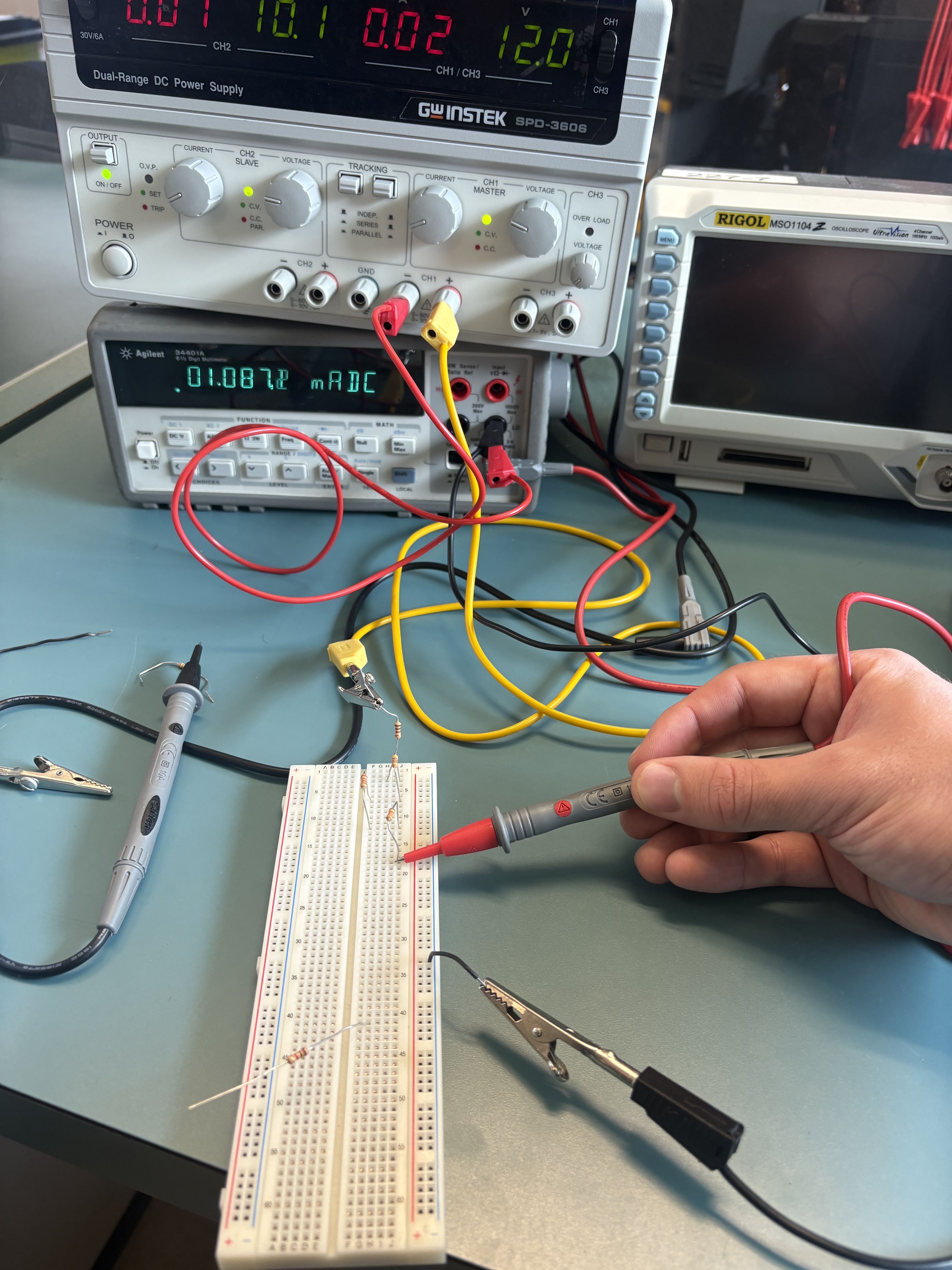 Your lab report photo showing current measurement leads and the long breadboard
