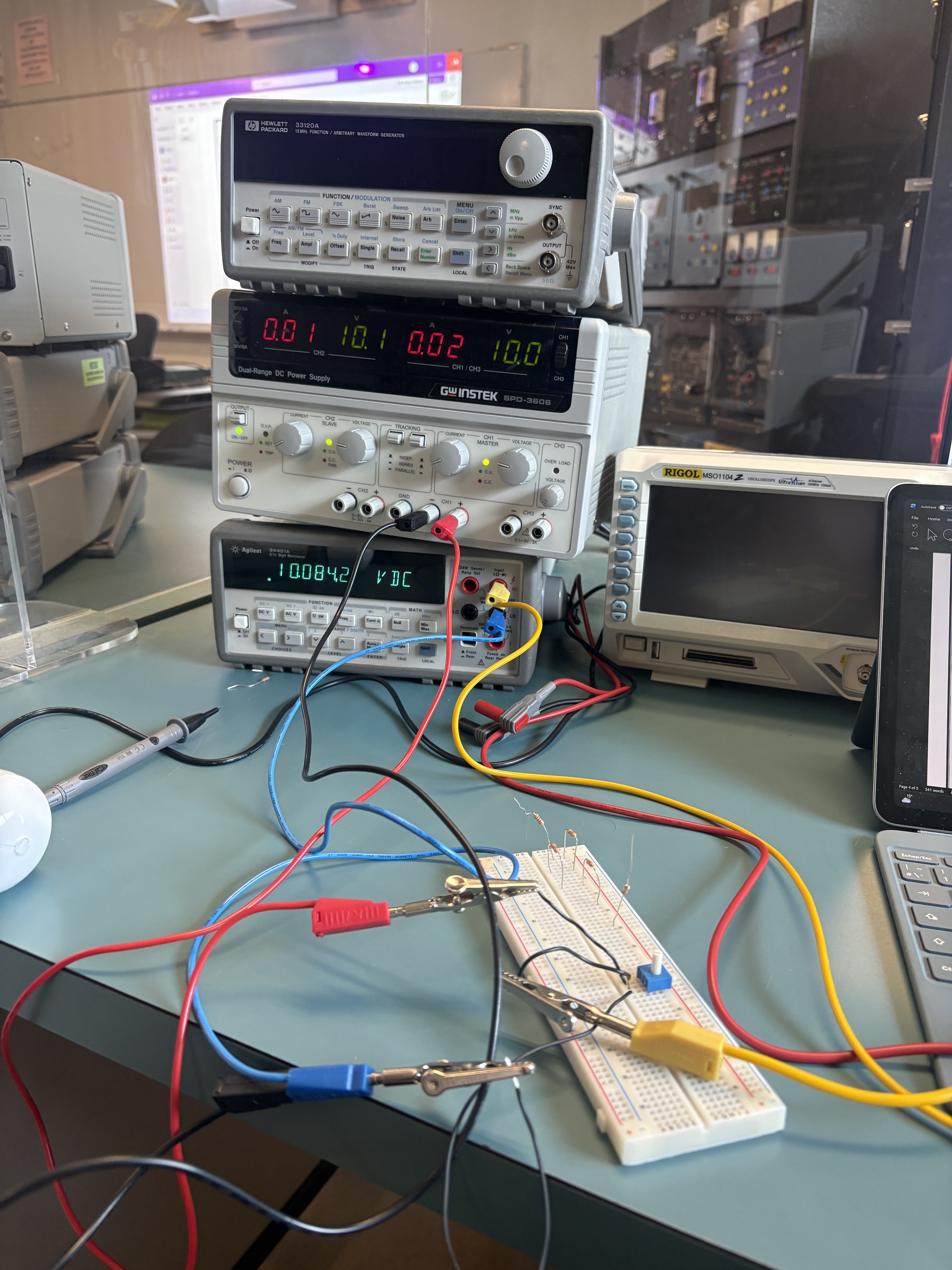 Your actual electronics bench with the generator, power supply and multimeter stacked beside a Rigol scope